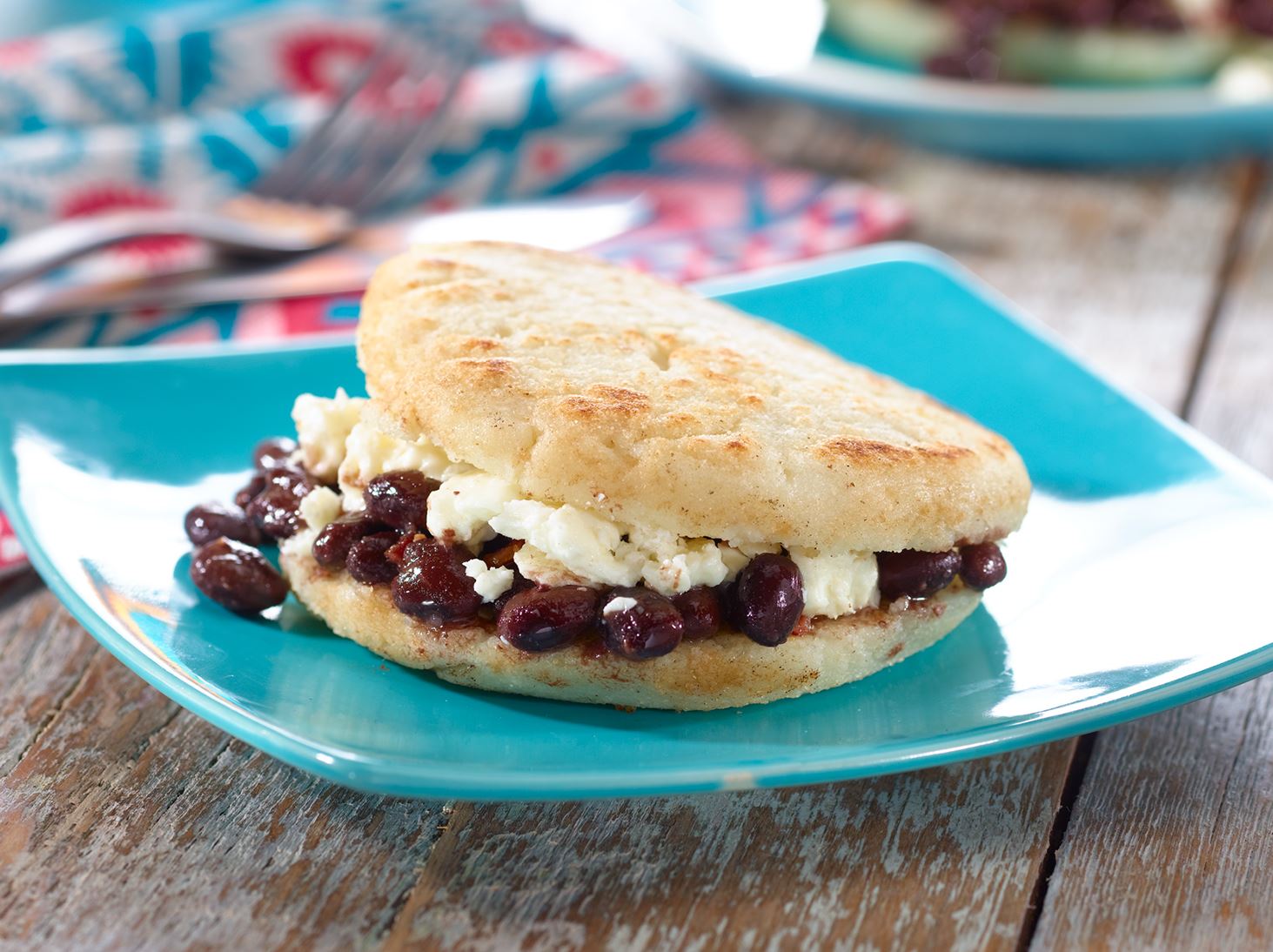 Arepa de Dominó - Venezuelan Corncake filled with Black Beans